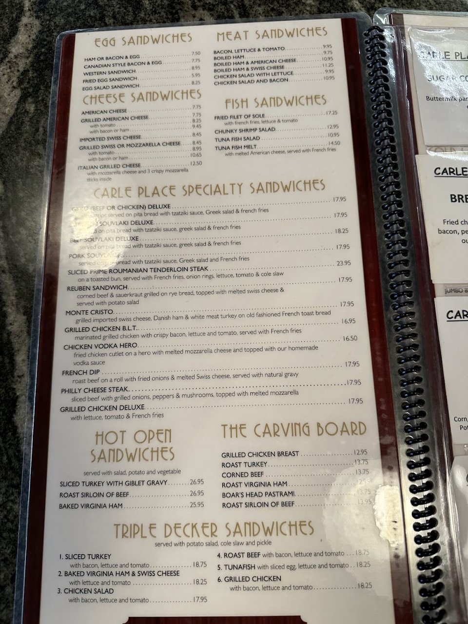 Printed diner menu with breakfast, sandwiches, and entrees.